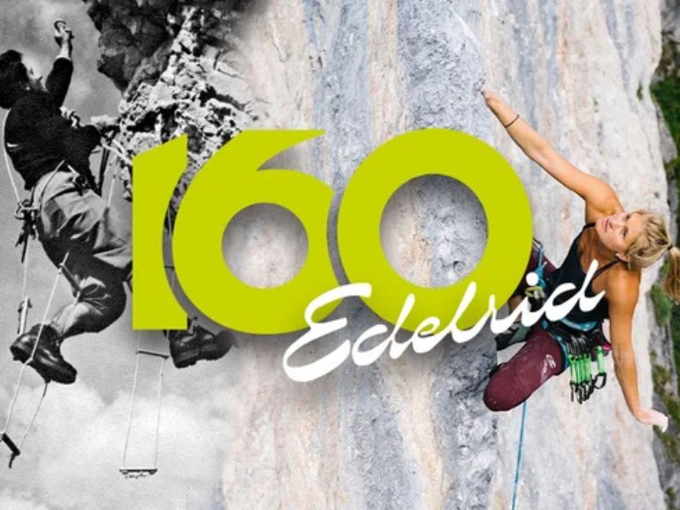 Una cuerda Edelrid enrollada sobre una superficie de roca o en una escena de montaña, con iluminación cálida (atardecer) y textura visible del trenzado.